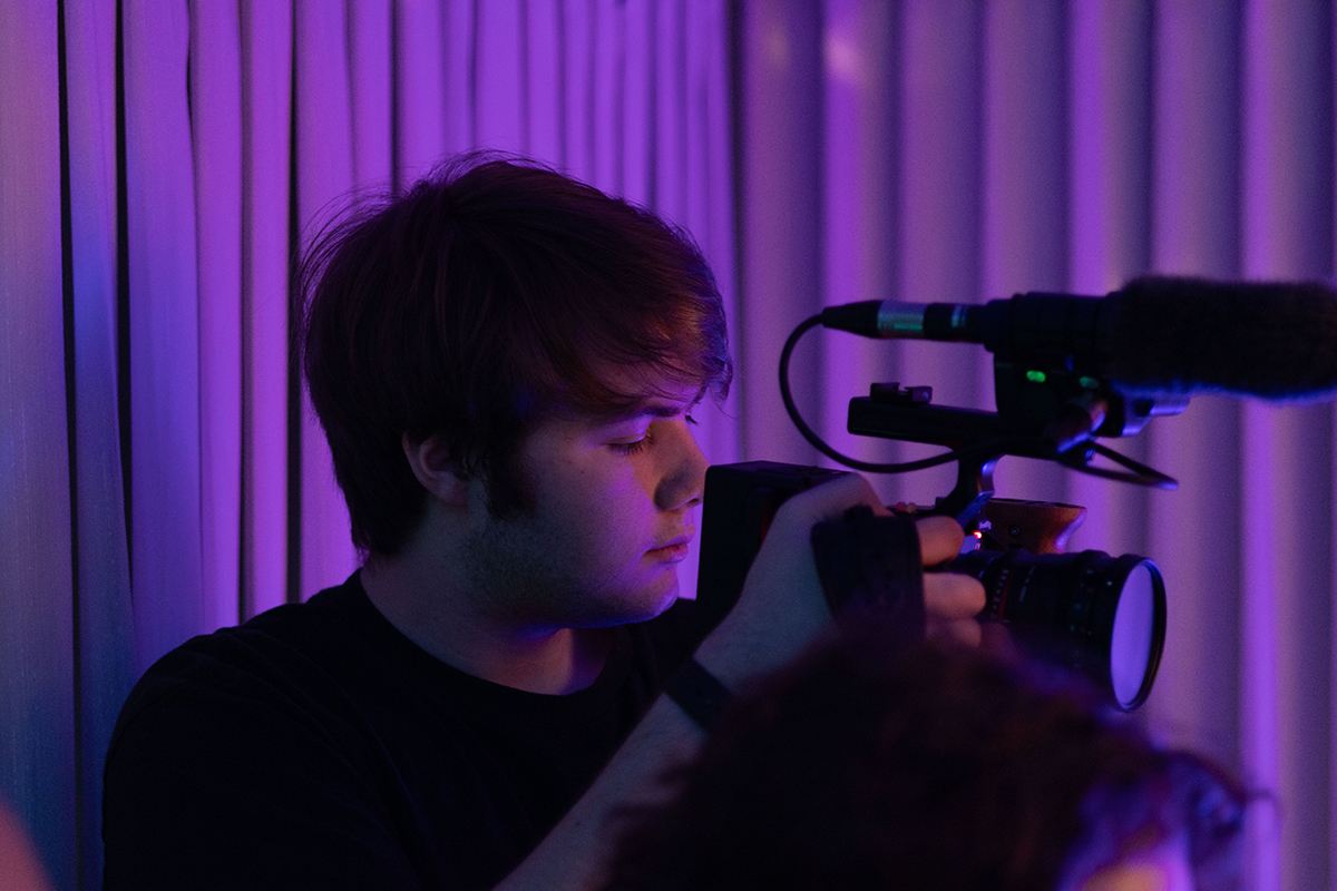 TAOS, Day 6, image 31 Logan Ehrhart works the camera during a party scene in The Anatomy of Sound. Photo credit: Eric Marshall