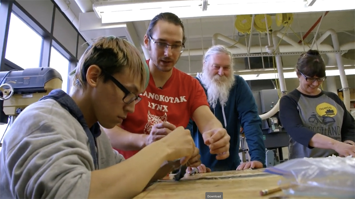 To Continue or Be Remembered Artist Joel Isaak helps a student with stitching. Still from To Continue or Be Remembered