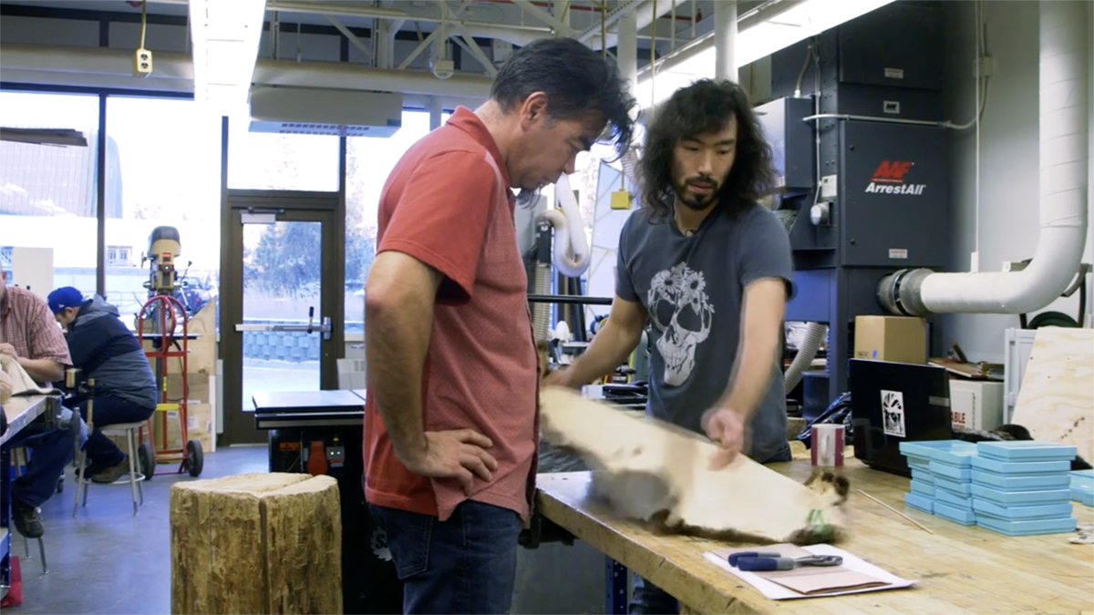 To Continue or Be Remembered Artists Peter Williams and Da-ka-xeen Mehner examine a skin. Still from To Continue or Be Remembered