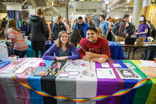 Students at an LGBTQ+ booth at UAF club fair