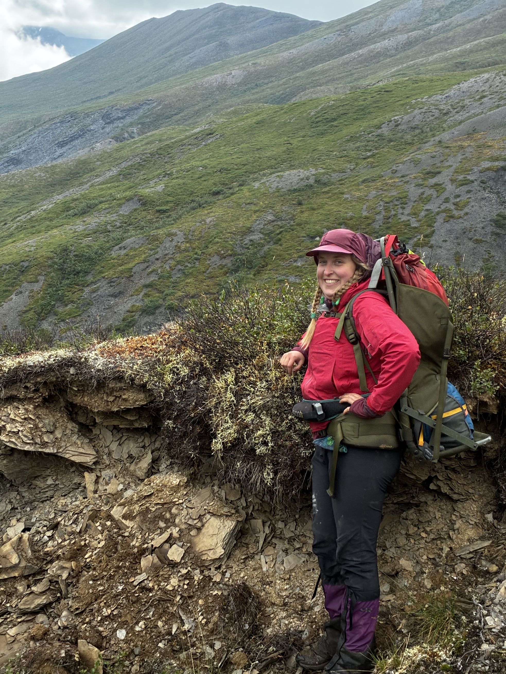 Kyra Bornong stands on a tundra slope