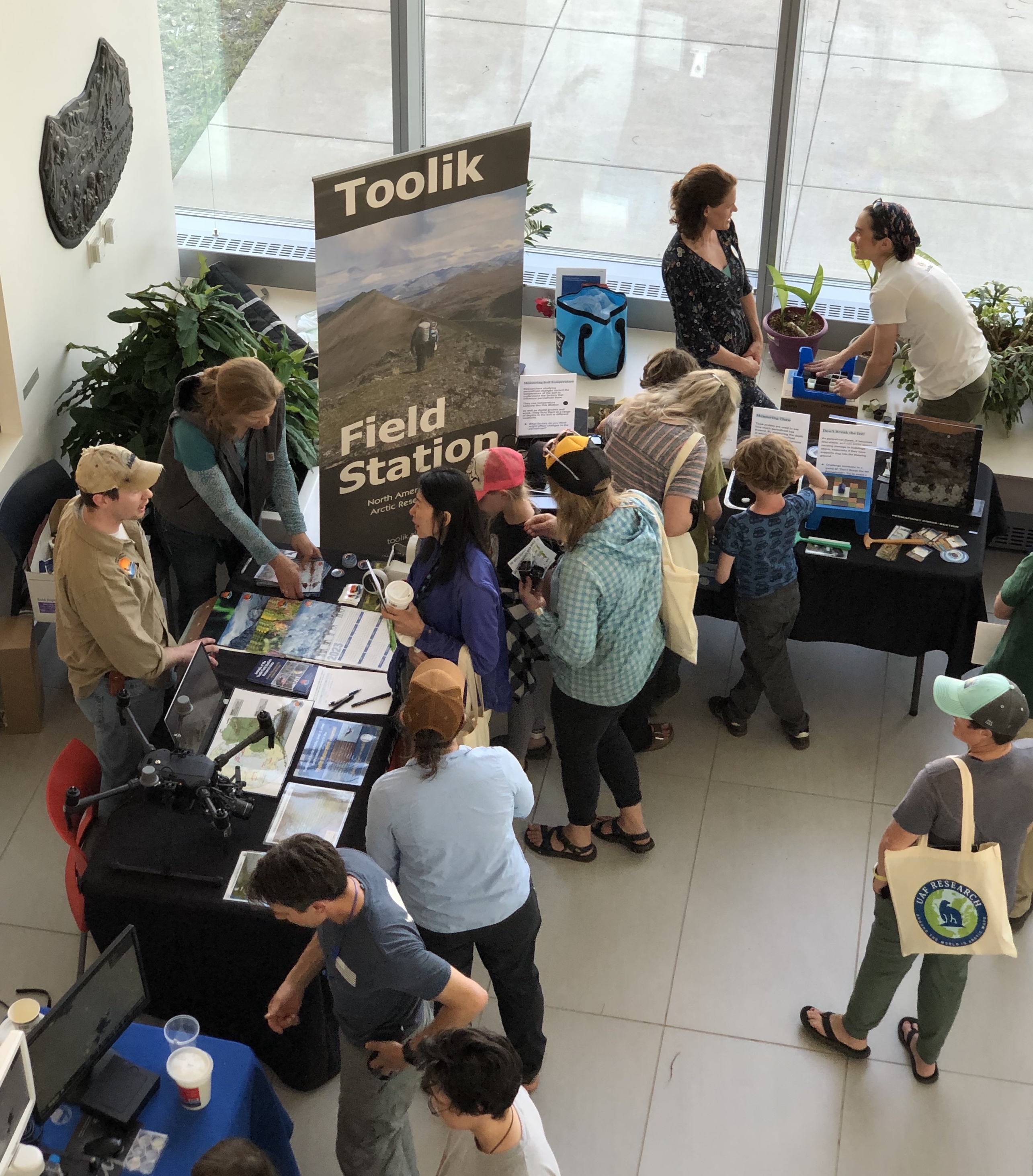 People standing at the Toolik Field Station booth at UAF's Arctic Research Open House