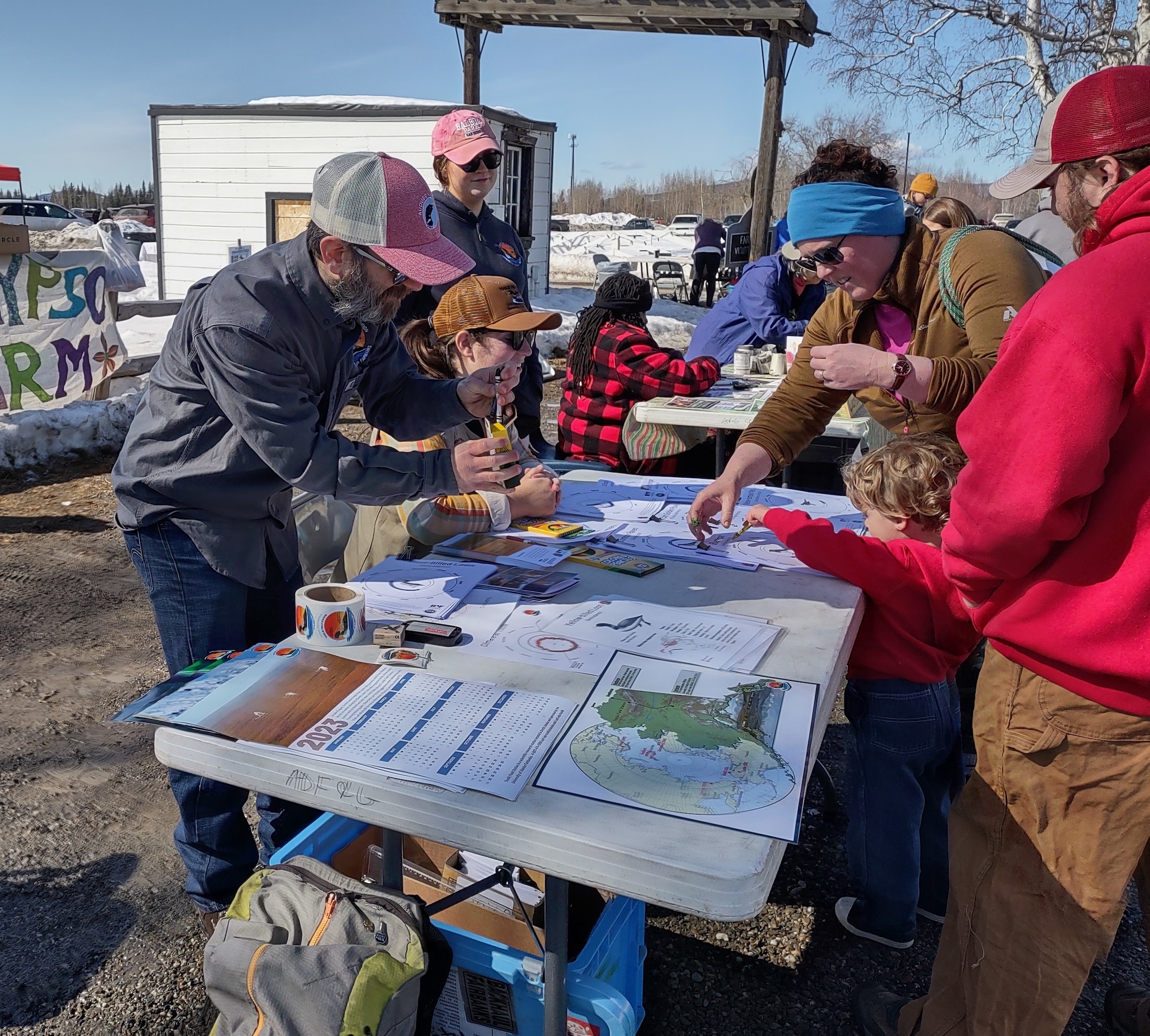 people stand at outreach table