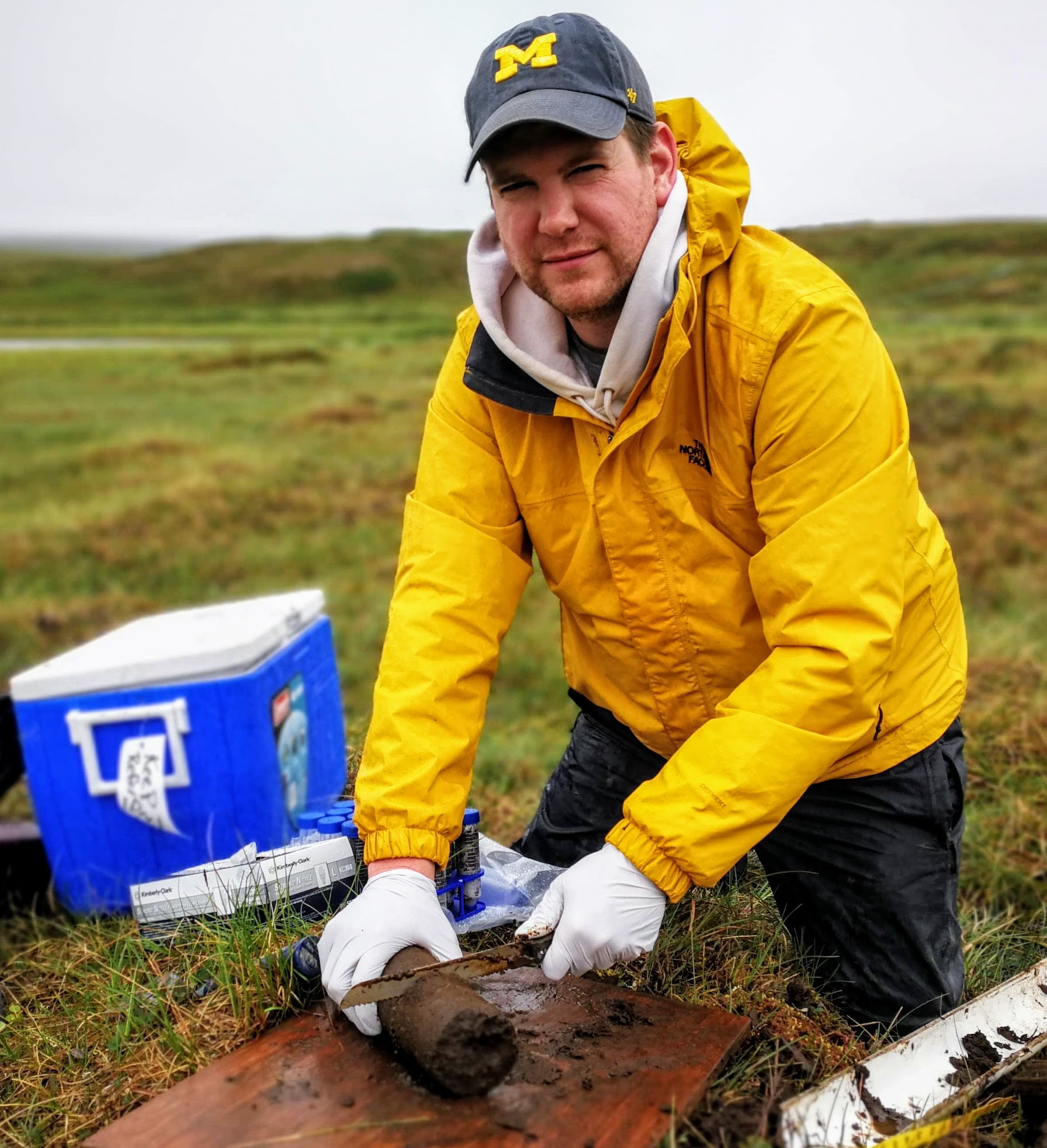 man cutting soil core