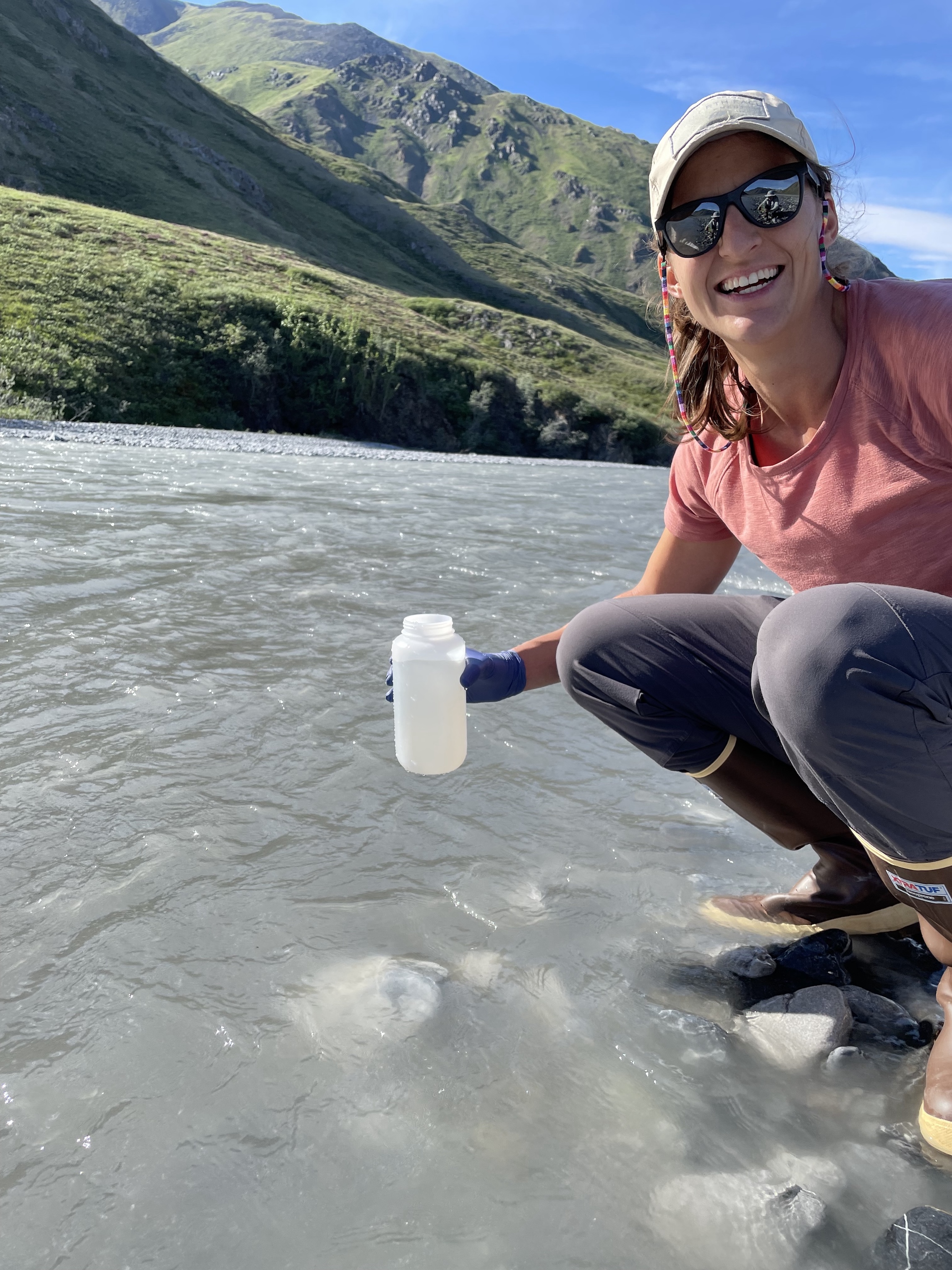 Marisa Repasch samples water from a mountain river