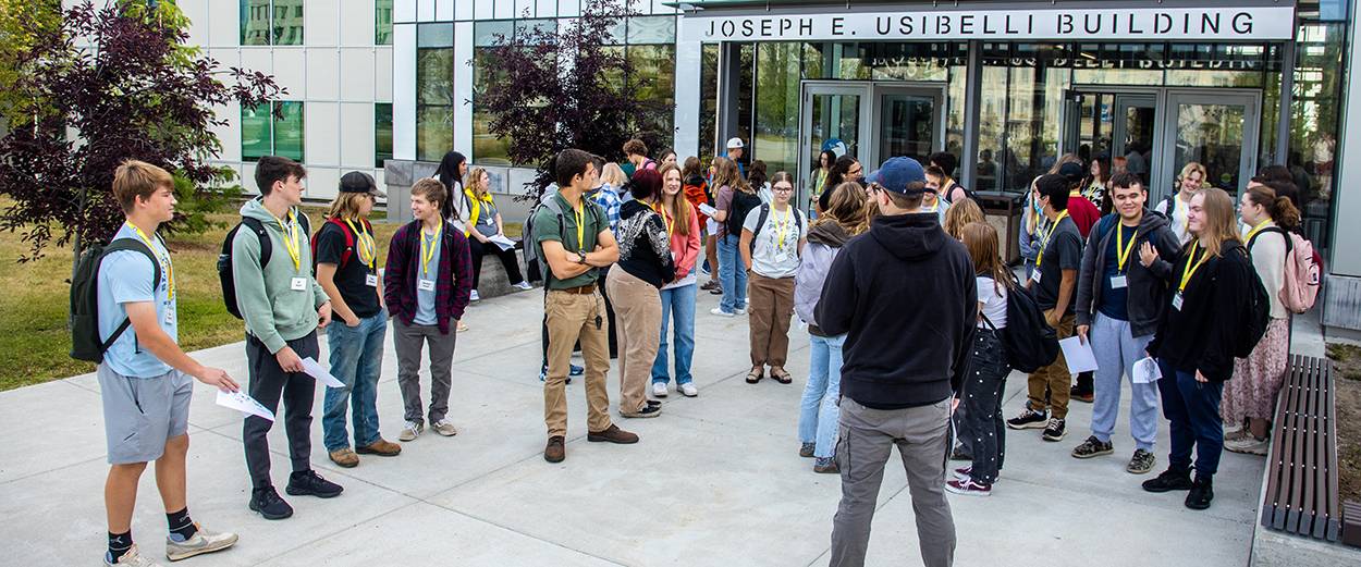 Prospective students touring the UAF gather outside the Usibelli Building on the Fairbanks Troth Yeddha' campus.