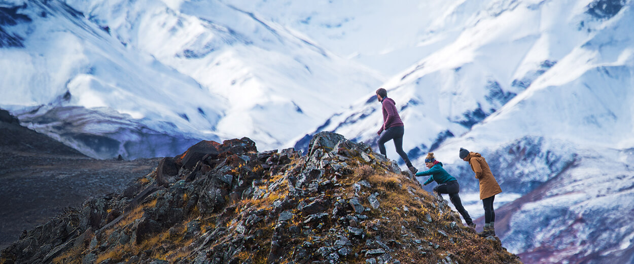Students hiking up a mountain ridge