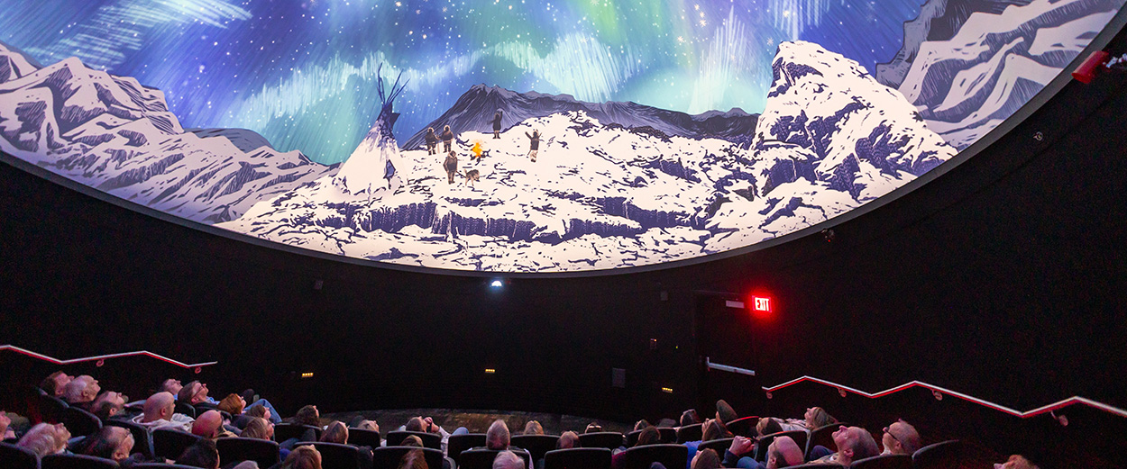 Planetarium visitors watch an aurora show in the dome