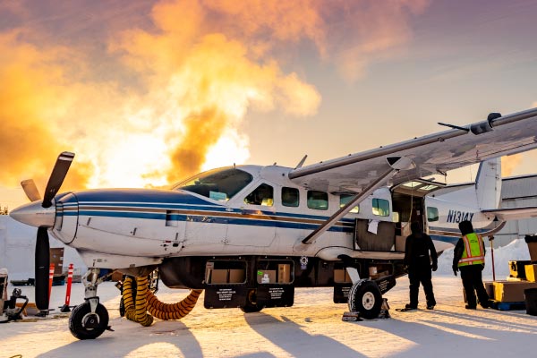 Wright Air Service employees in Fairbanks load a Cessna Grand Caravan bound for the Yukon River village of Nulato on the morning of Jan. 23, 2024, when the temperature was about minus 35 Fahrenheit.