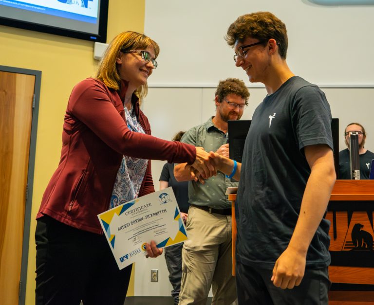 A student getting an award by a staff member