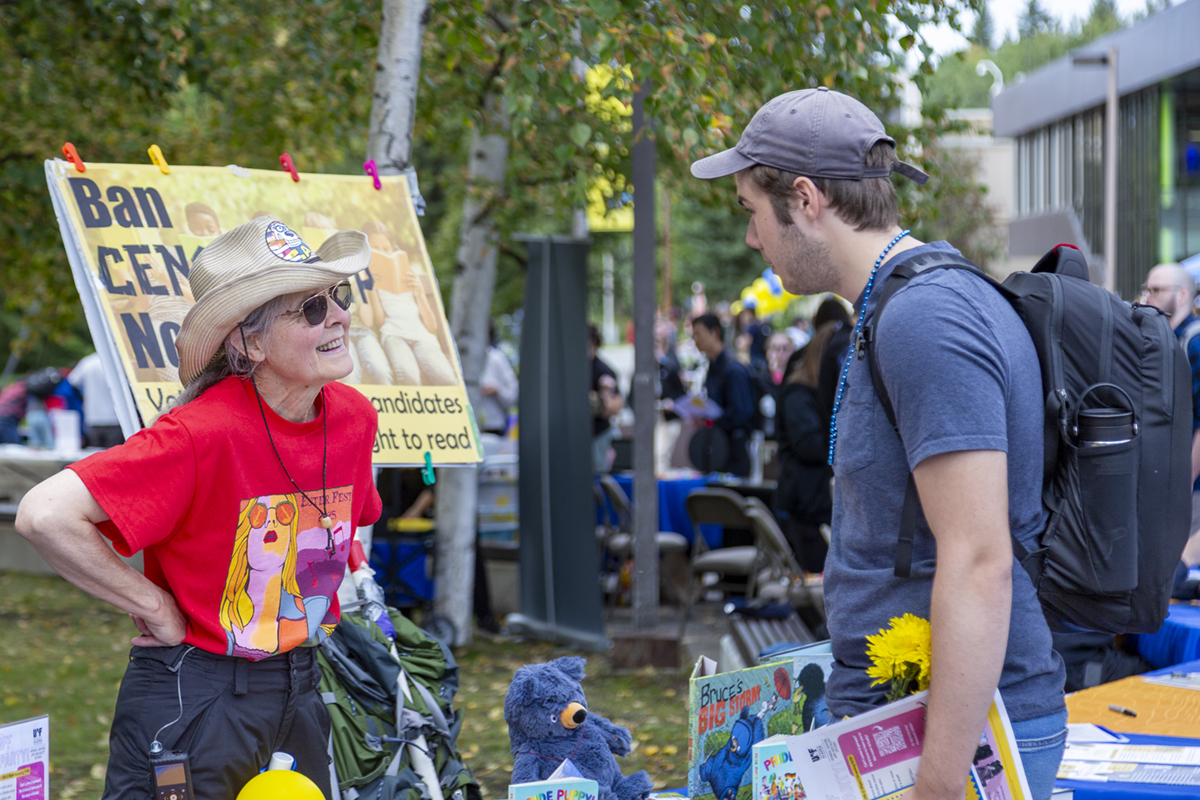 Kayt Sunwood speaks with a new student at UAF's 2025 Party in the Park